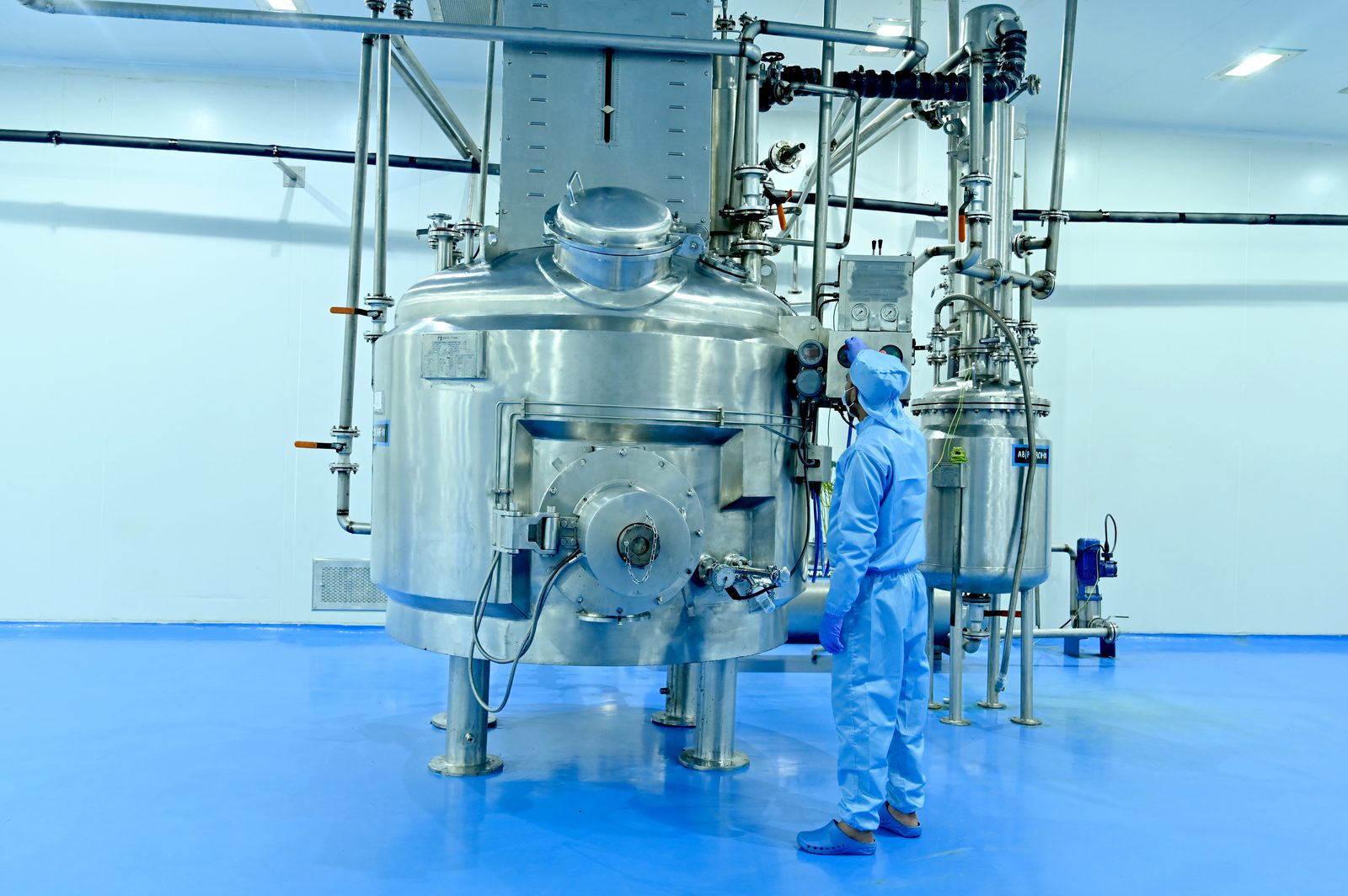Technician inspecting a large reactor vessel