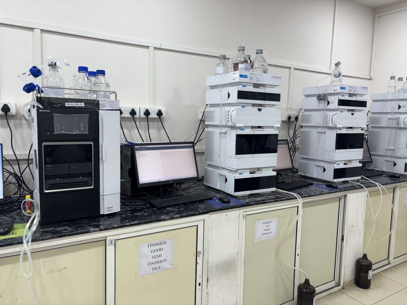 Row of HPLC instruments in the QC lab