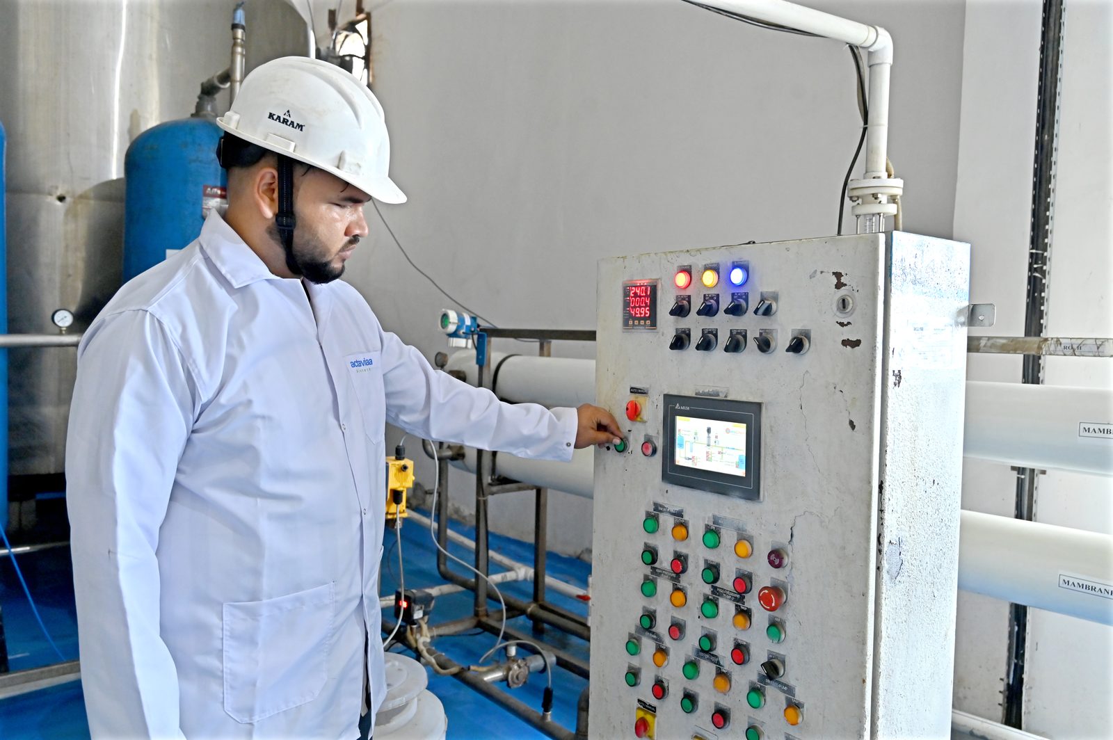 Operator monitoring a water treatment control panel